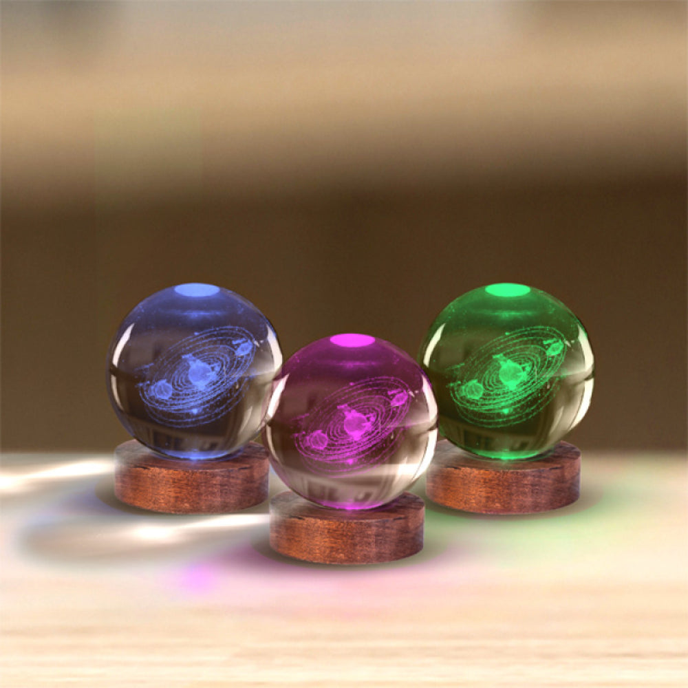 Three colorful glass balls on wooden stands with a blurred background