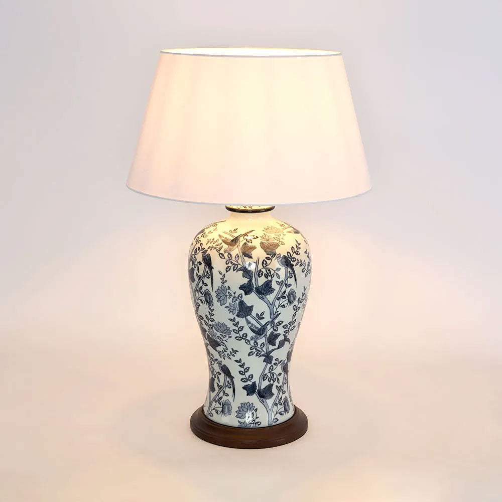Decorative table lamp with floral patterns on a plain background