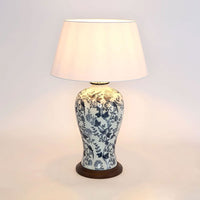 Decorative table lamp with floral patterns on a plain background