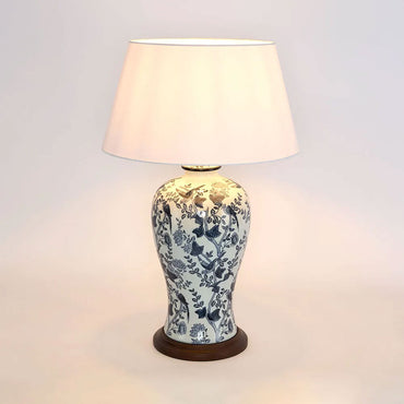 Decorative table lamp with floral patterns on a plain background