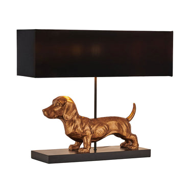 Table lamp with a gold dachshund-shaped base and black rectangular shade on a white background