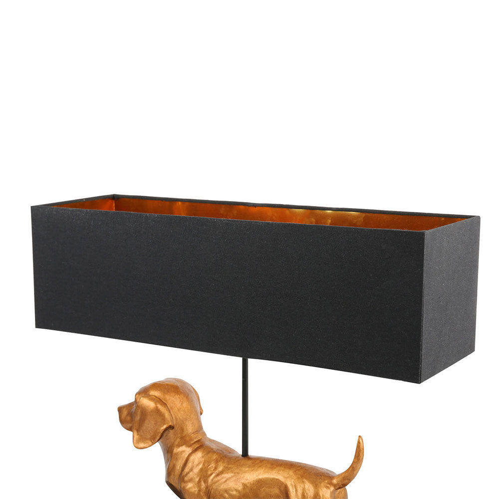 Black rectangular lampshade on a white background with a gold dog sculpture.