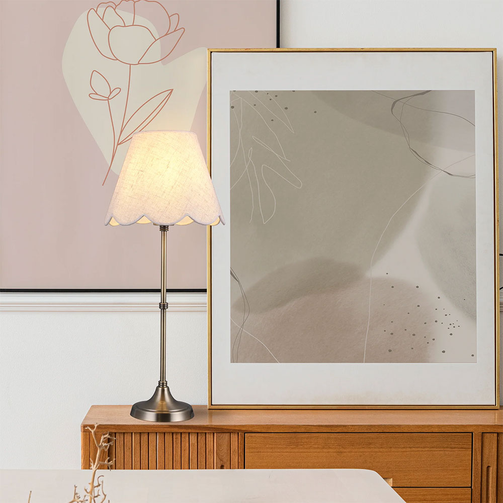 Table lamp on a wooden surface with abstract art in the background