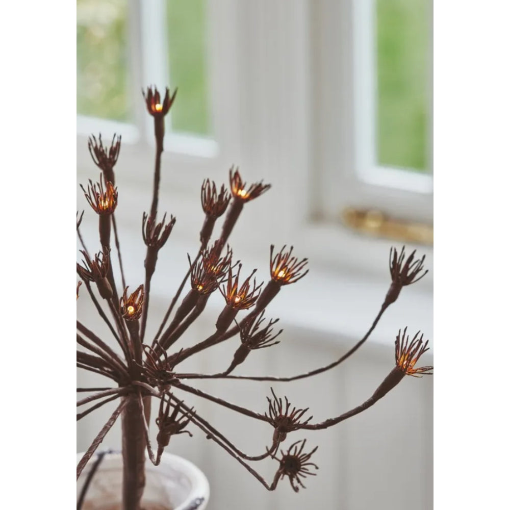 Decorative twig with lights against a neutral background