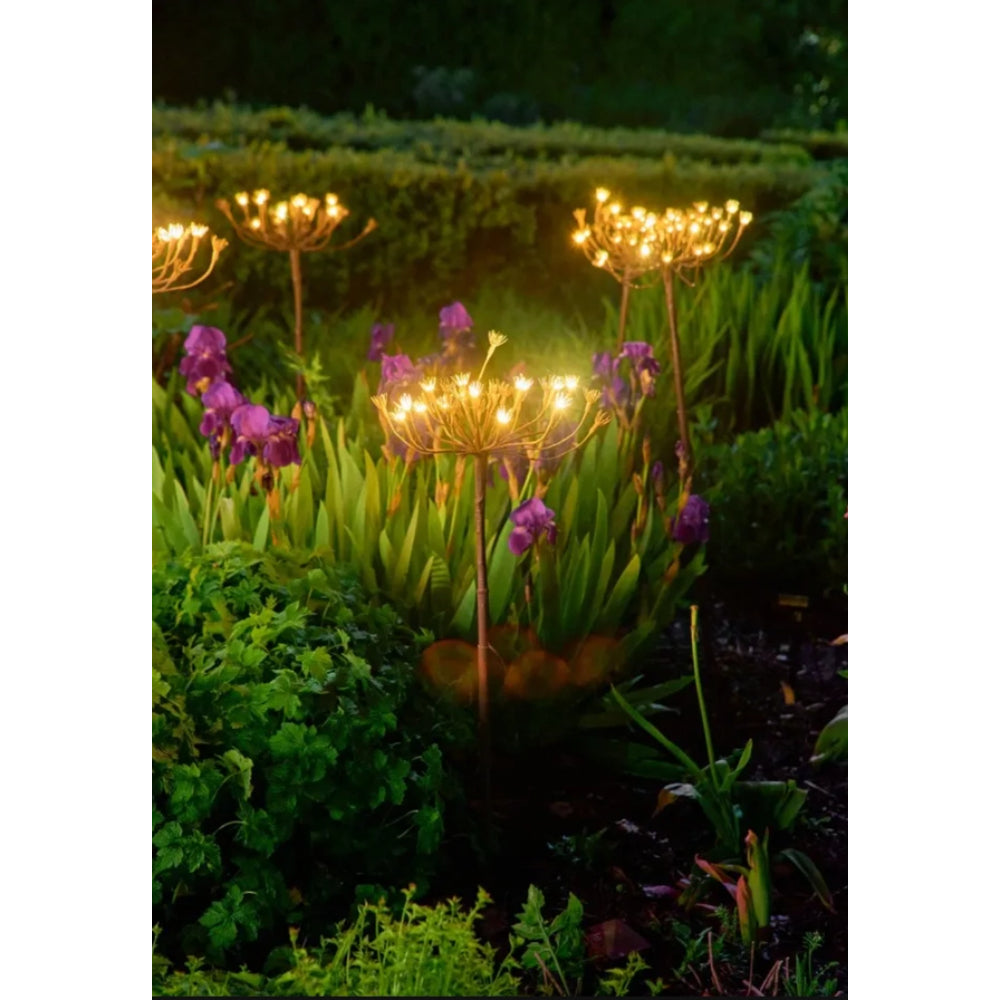 Garden lights with flowers in a garden setting