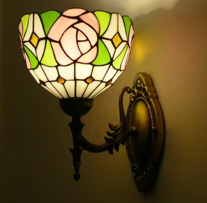 Decorative wall lamp with stained glass shade on a dark background