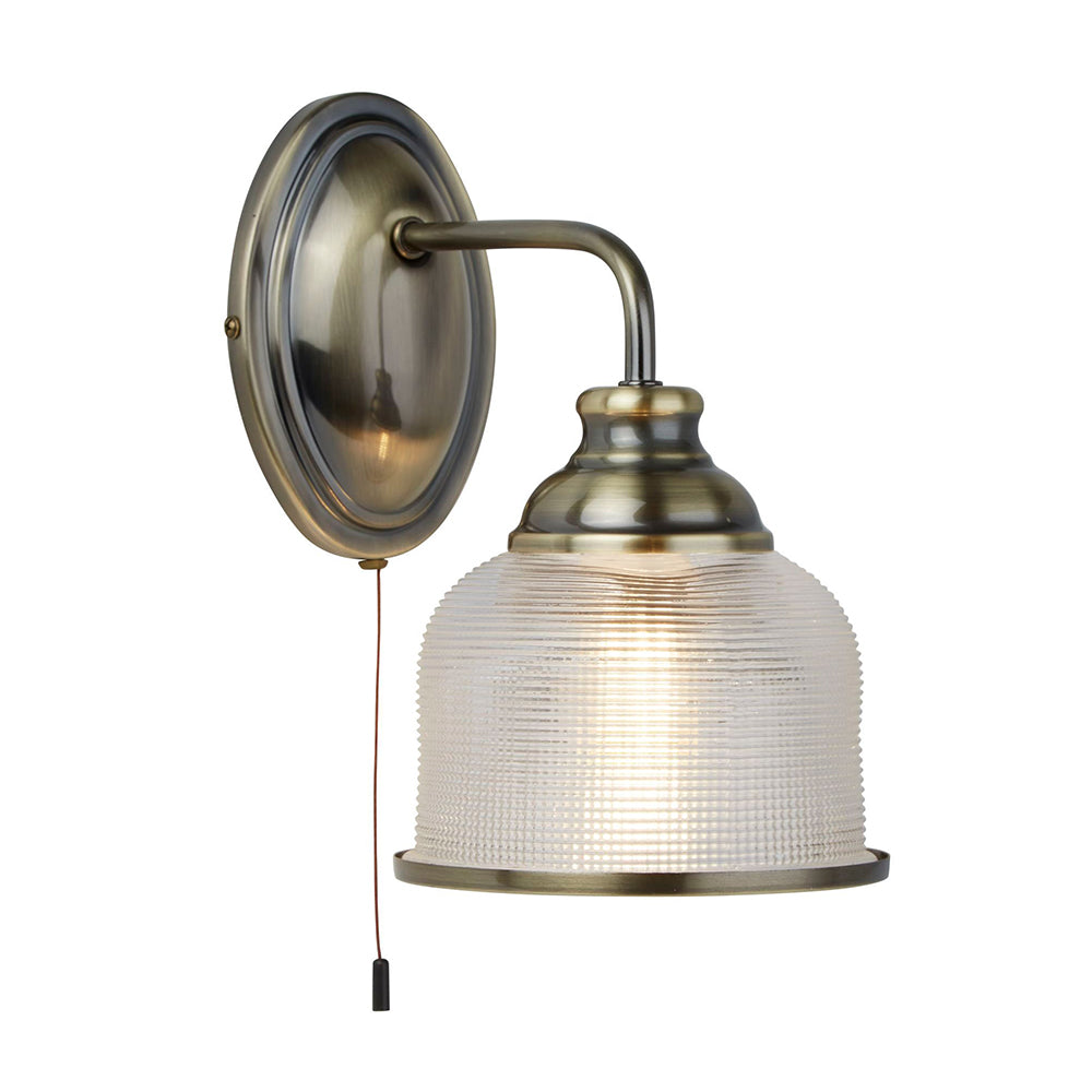 Wall-mounted lamp with metallic fixture and textured glass shade on a white background